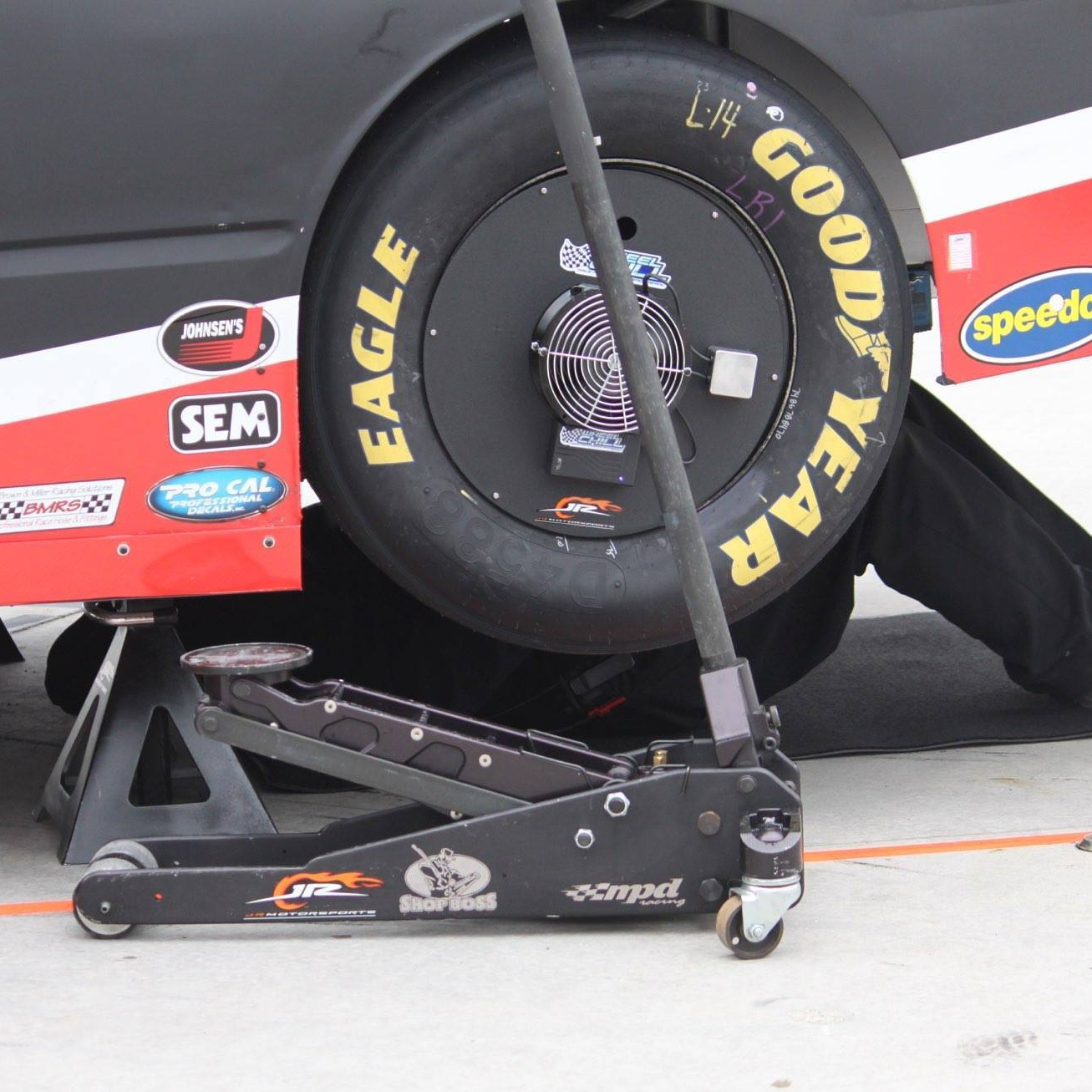 A Wireless Wheel Chill in use on a racecar that is being worked on